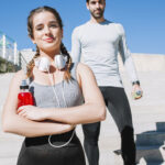 athletic couple on stairs outdoors exercising