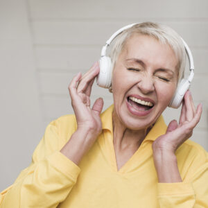 mature woman listening to music on headphones